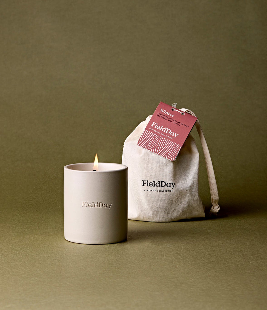 FieldDay candle and drawstring bag on a green background